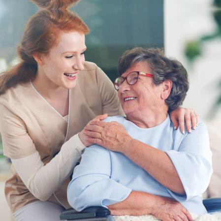 caregiver and senior woman looking at each other