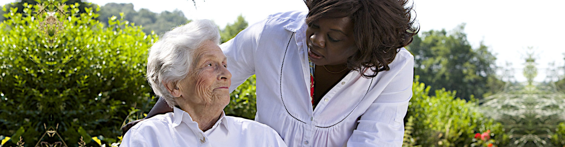 caregiver and senior woman looking at each other