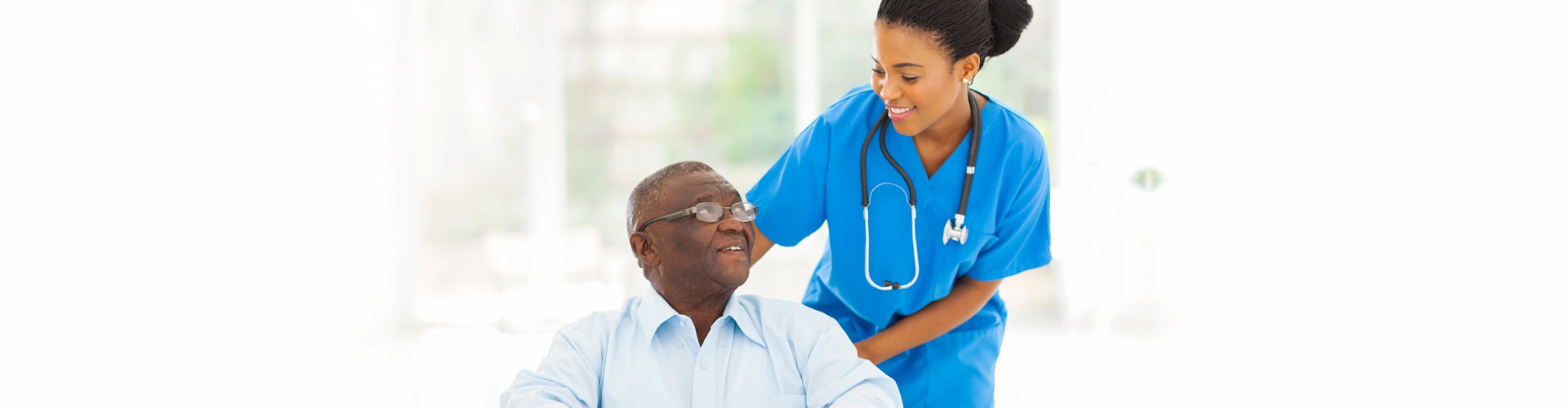 caregiver and senior man looking at each other