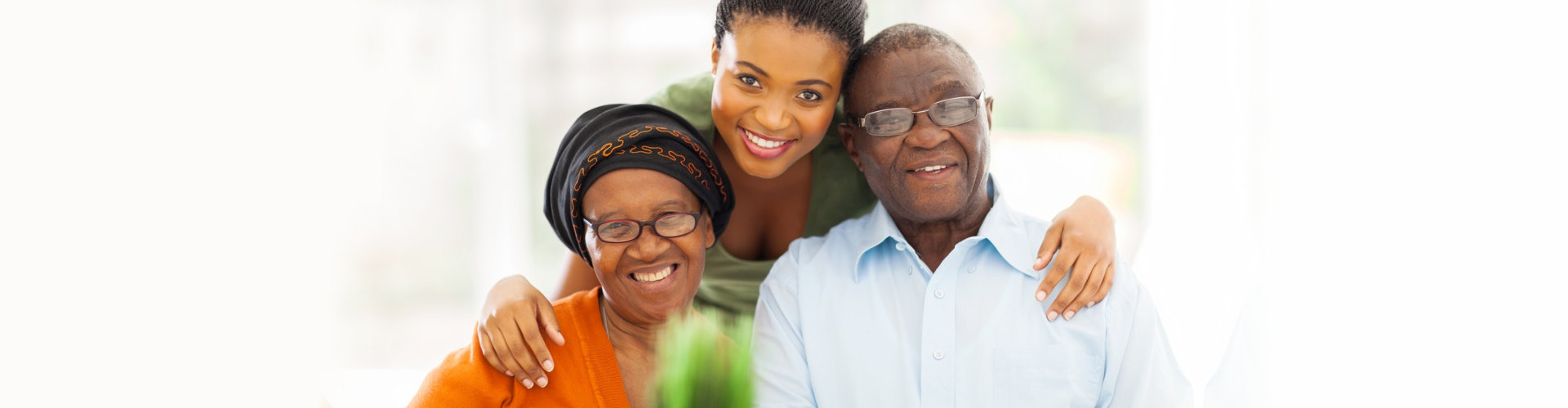 adult woman and senior couple smiling