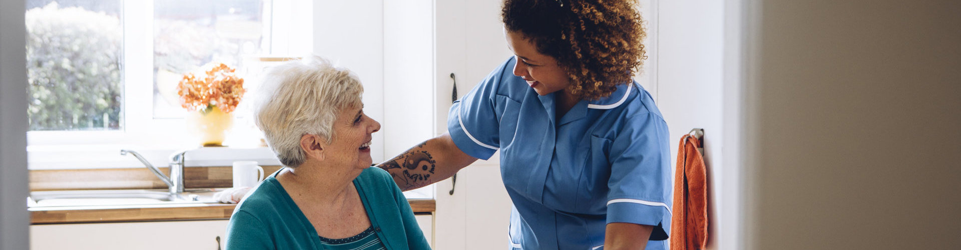 caregiver and senior woman looking at each other